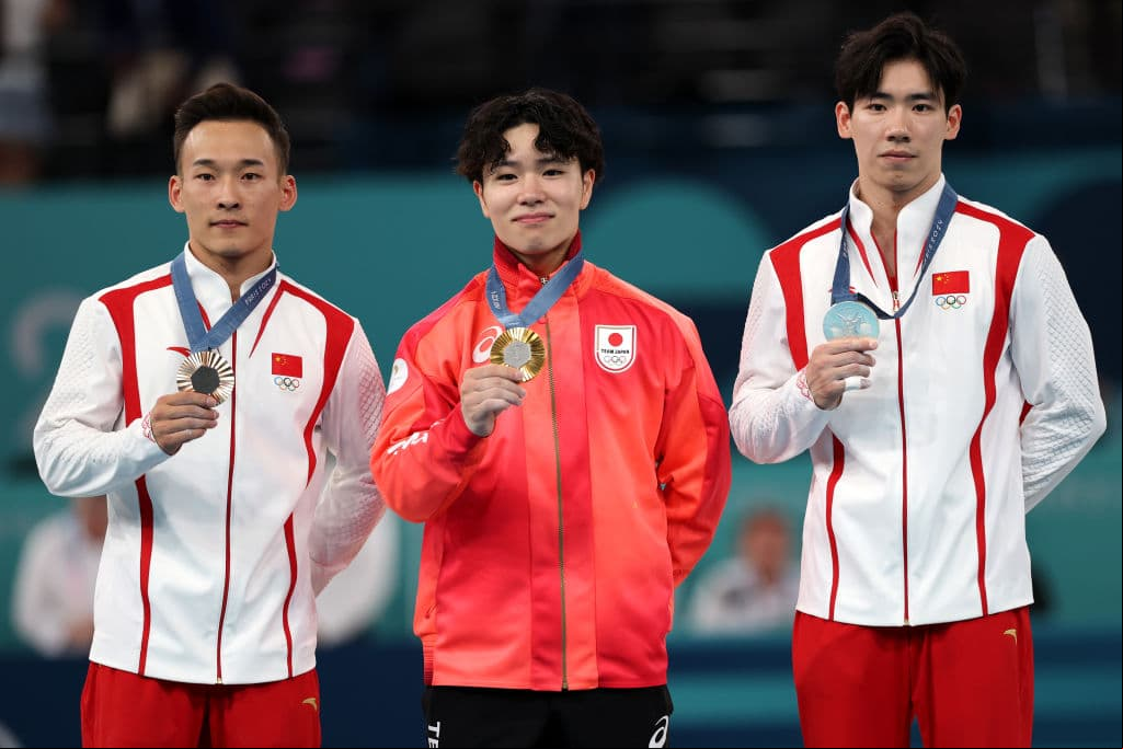 PARIS,  - JULY 31: (L-R) Bronze medalist Xiao Ruoteng of Team People's Republic of China, Gold medalist Shinnosuke Oka of Team Japan and Silver medalist Zhang Boheng of Team People's Republic of China pose with their medals on the podium during the medal ceremony for the Artistic Gymnastics Men's All-Around Final on day five of the Olympic Games Paris 2024 at Bercy Arena on July 31, 2024 in Paris, . (Photo by Jamie Squire/Getty Images)
