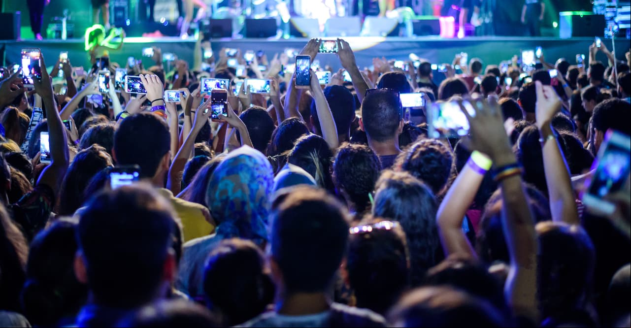 People filming a concert