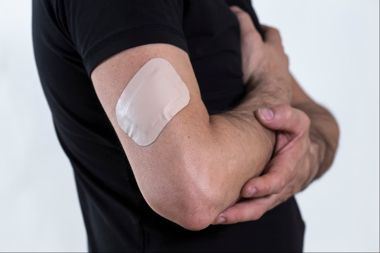 Man with a big bandage on his arm