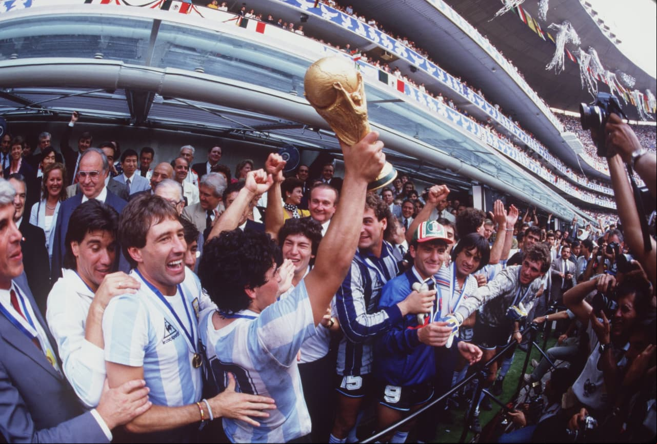 JUL 1986: DIEGO MARADONA OF ARGENTINA LIFTS THE WORLD CUP TROPHY IN FRONT OF THE WORLD's MEDIA AFTER ARGENTINA BEAT  3-2 TO WIN THE 1986 SOCCER WORLD CUP FINAL. Mandatory Credit: Mike King/ALLSPORT