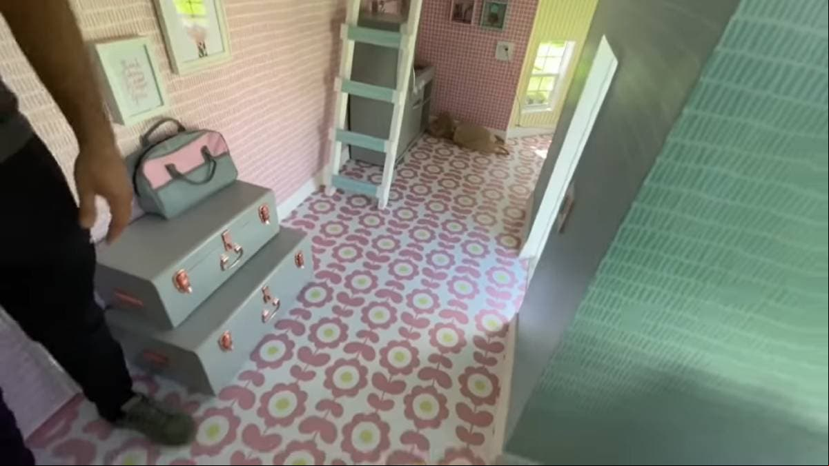 En la parte de abajo de las escaleras, está ubicada la cocina, en la que se observan los muebles en color gris oscuro junto a grandes ventanales.