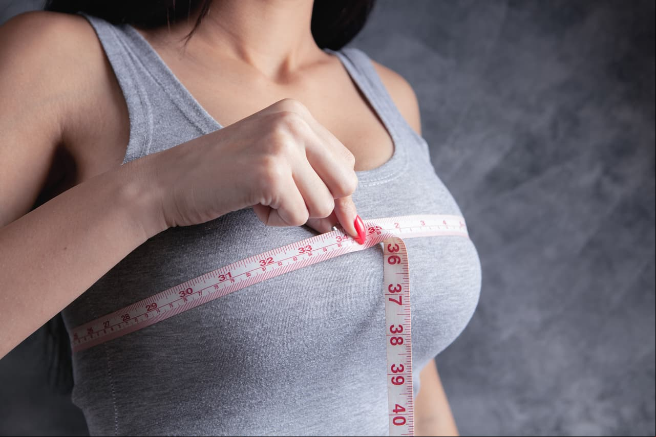 young girl measures her breasts